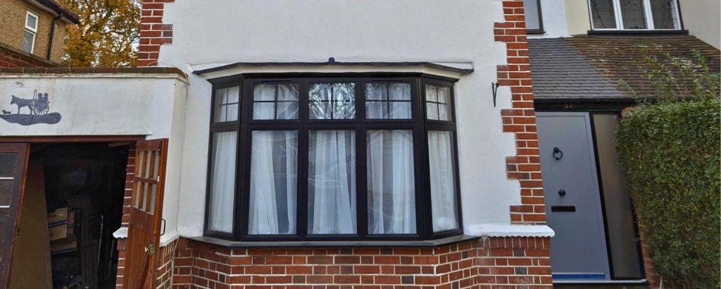 A london home with aluminium black heritage black bay window by Durajoin
